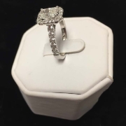 custom 1.80ct emerald radiant cut diamond surrounded by 1.42ct smaller diamonds all set in 18kt white gold