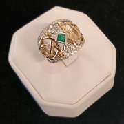 14k custom ring with Celtic design set with emerald centre with two round diamonds on each end with 1ct of diamonds surrounding centre