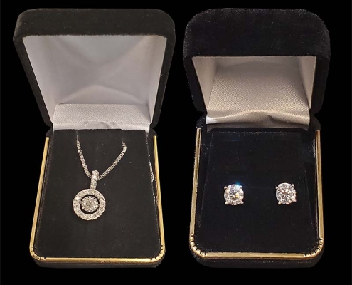 diamond pendant on white gold chain with matching diamond stud earrings